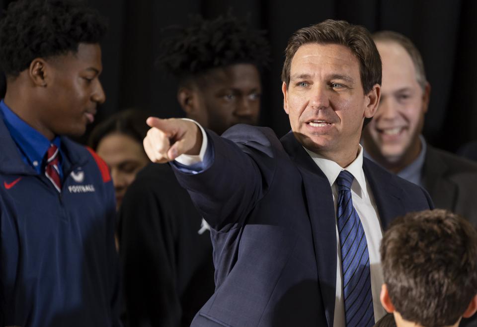 Florida Governor Ron DeSantis takes questions from the media during a press conference at Christopher Columbus High School on Monday, March 27, 2023, in Miami, Fla. The press conference was held to announce DeSantis's signing of a private school voucher expansion, HB1, which allows more Florida school children become eligible for taxpayer-funded school vouchers.(Matias J. Ocner/Miami Herald via AP)