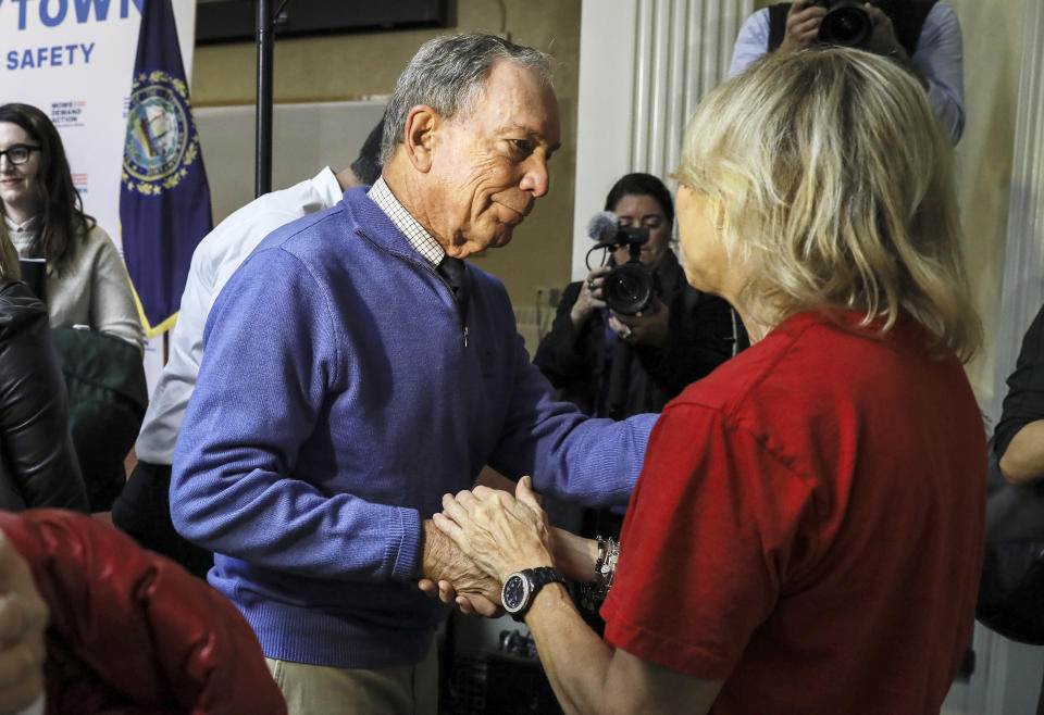 Former New York Mayor Michael Bloomberg talks to a woman who lost her daughter to gun violence after speaking at a rally at City Hall in Nashua, N.H. Saturday, Oct. 13, 2018. (AP Photo/ Cheryl Senter)