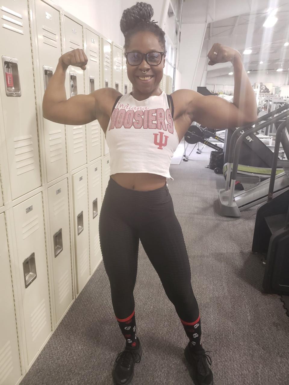 Taneisha Henline flexes her muscles as she trained for the 2022 NPC Natural Indiana Championships at Beech Grove High School.