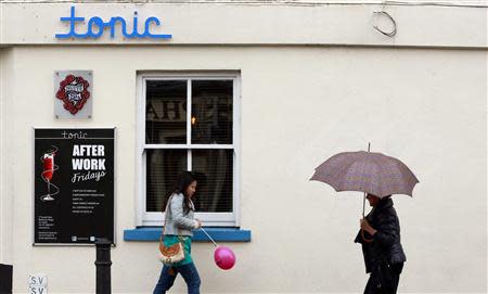 People walk past the 'tonic' bar and nightclub in the village of Blackrock, County Dublin, Ireland November 6, 2013. REUTERS/Cathal McNaughton