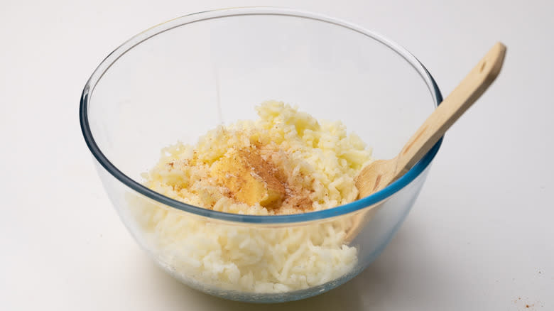 mixing butter into mashed potato