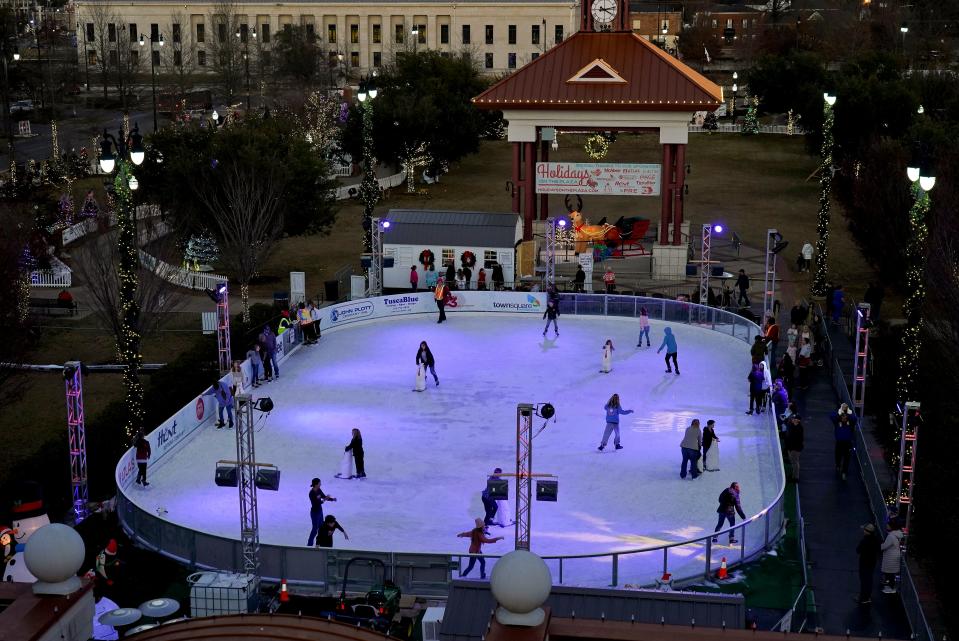 Ice skaters zip around the rink in Government Plaza Wednesday, Dec. 22, 2021. [Staff Photo/Gary Cosby Jr.]