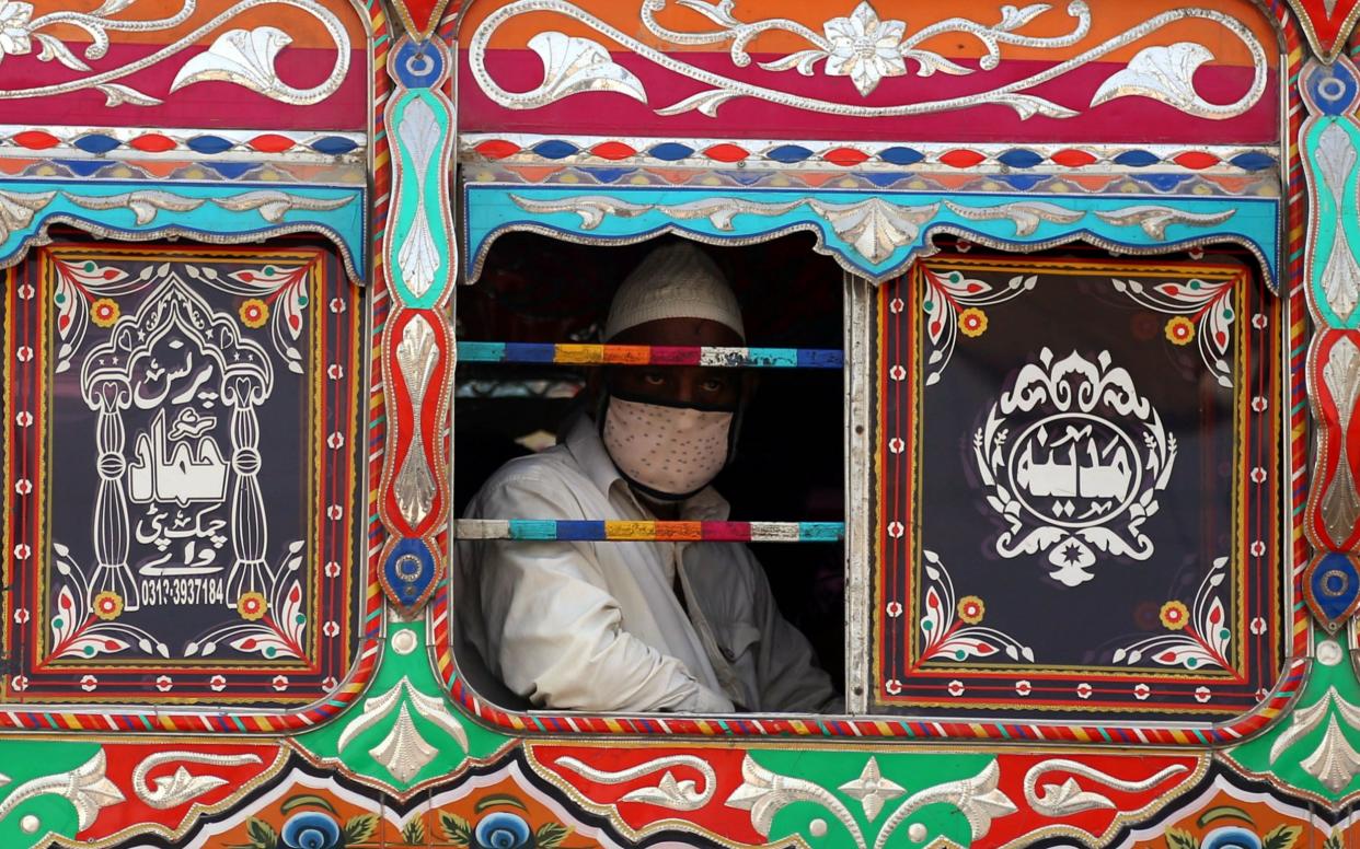 A man wears protective mask on public transport in Karachi, Pakistan - REHAN KHAN/EPA-EFE/Shutterstock
