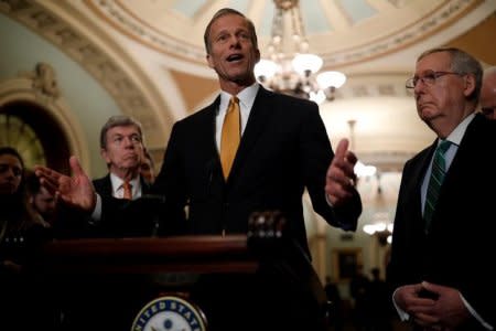 Sen. John Thune (R-SD), accompanied by Senate Majority Leader Mitch McConnell and Sen. Roy Blunt (R-MO), speaks with reporters following the weekly policy luncheons at the U.S. Capitol in Washington, U.S., February 13, 2018. REUTERS/Aaron P. Bernstein