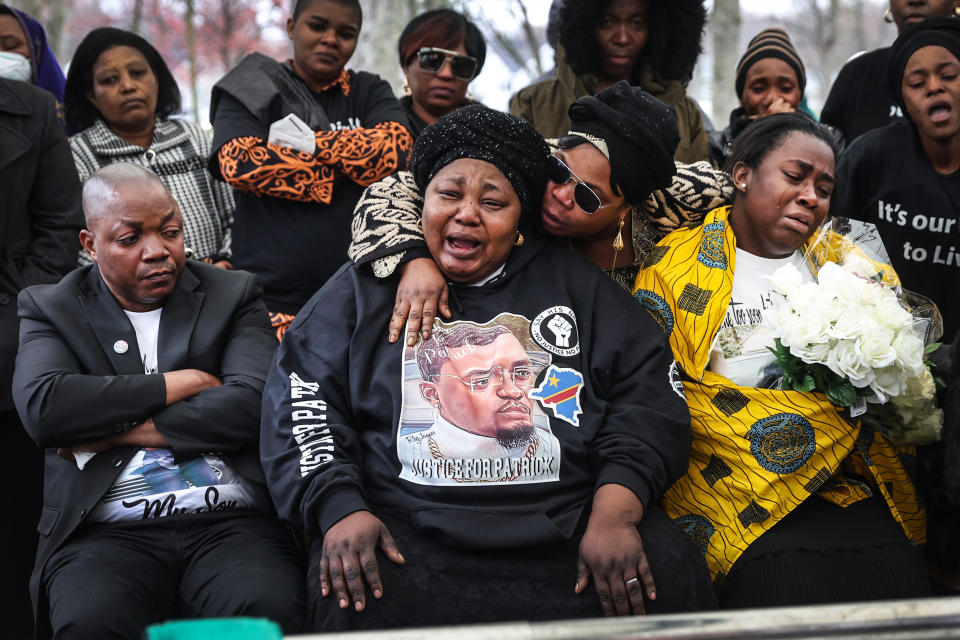 Image: Dorcas Lyoya, center, the mother of Patrick Lyoya, is comforted as she grieves the loss of her son while he is laid to rest at Resurrection Cemetery on April 22, 2022 in Wyoming, Mich. (Scott Olson / Getty Images file)