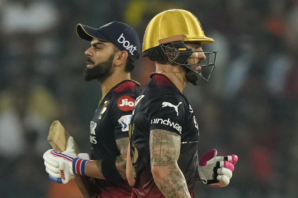 Royal Challengers Bangalores' Faf du Plessis , right, and Virat Kohl run between wickets during the Indian Premier League cricket match between Sunrisers Hyderabad and Royal Challengers Bangalore in Hyderabad, India, Thursday, May 18, 2023. (AP Photo/Mahesh Kumar A.)