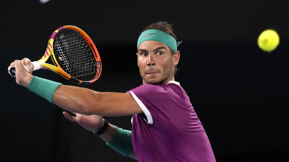 Rafael Nadal of Spain plays a backhand return to Matteo Berrettini of Italy during their semifinal match at the Australian Open tennis championships in Melbourne, Australia, Friday, Jan. 28, 2022. (AP Photo/Simon Baker)