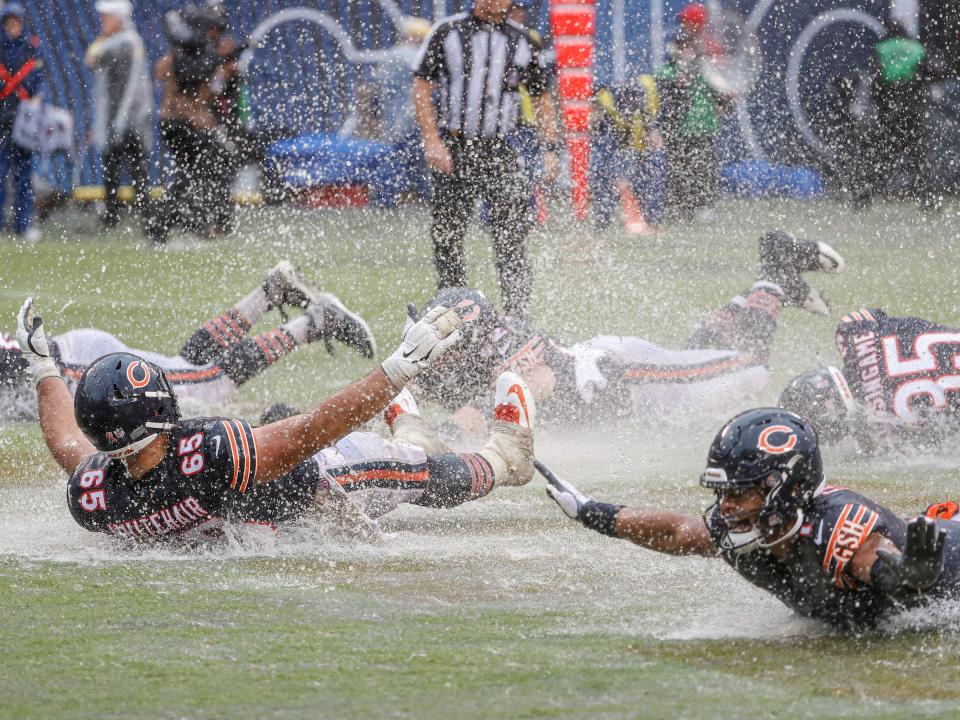 The Chicago Bears celebrate a win over the San Francisco 49ers in the pouring rain.