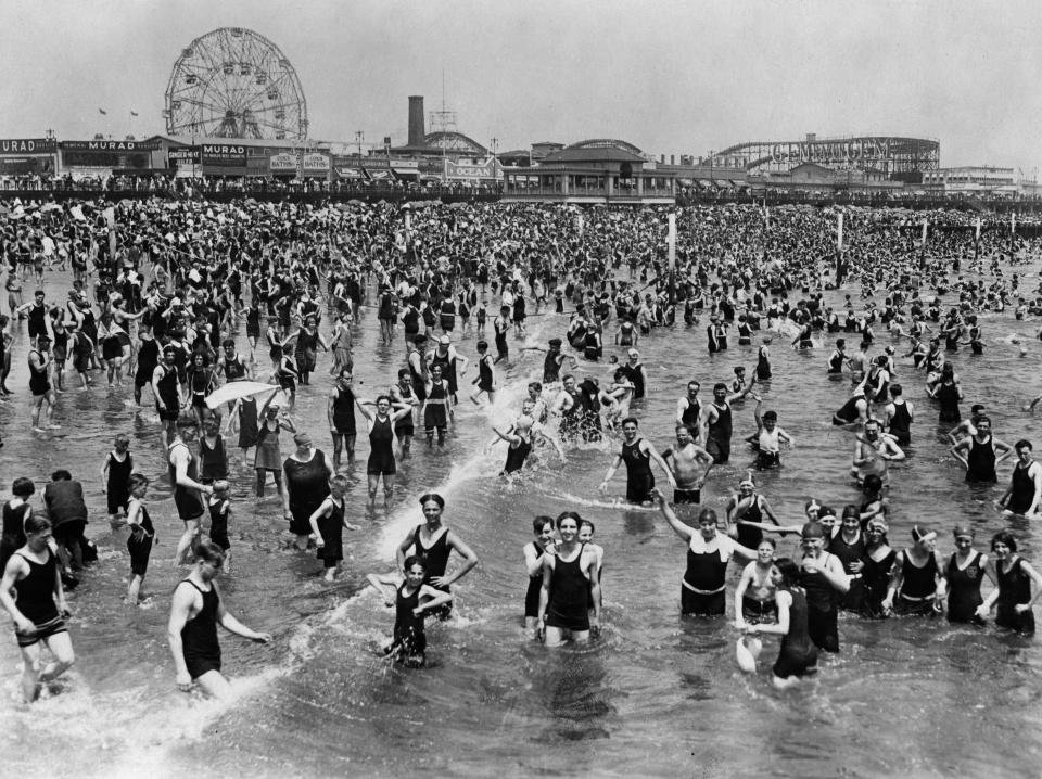 The beach at Coney Island with the amusement park in the background, 1928.