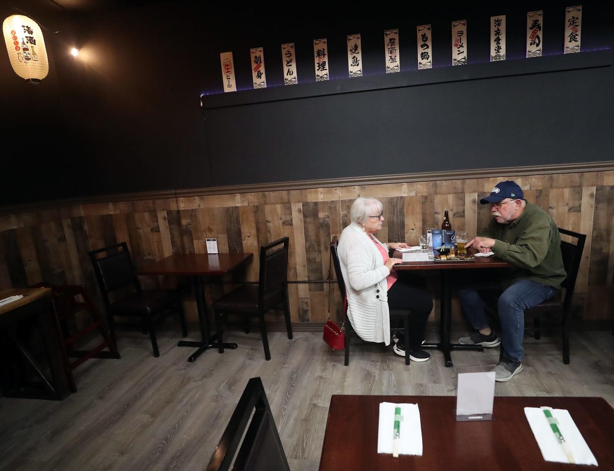 Tom Posey points out his next choice from the variety plate of yakitori that he and his wife Peggy were sharing at Oishi Japanese Kitchen in Bremerton on Monday, Nov. 20, 2023.