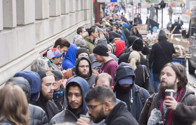 People are seen here waiting in line to purchase legal cannabis products outside a government cannabis store in Montreal on Oct.17, 2018. Photo from The Canadian Press.