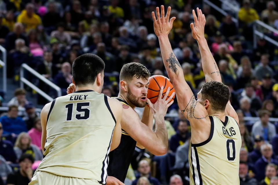 Michigan center Hunter Dickinson (1) is defended by Purdue center Zach Edey (15) and forward Mason Gillis (0) during the first half at Crisler Center in Ann Arbor on Thursday, Jan. 26, 2023.