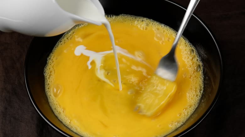 cream poured into scrambled eggs