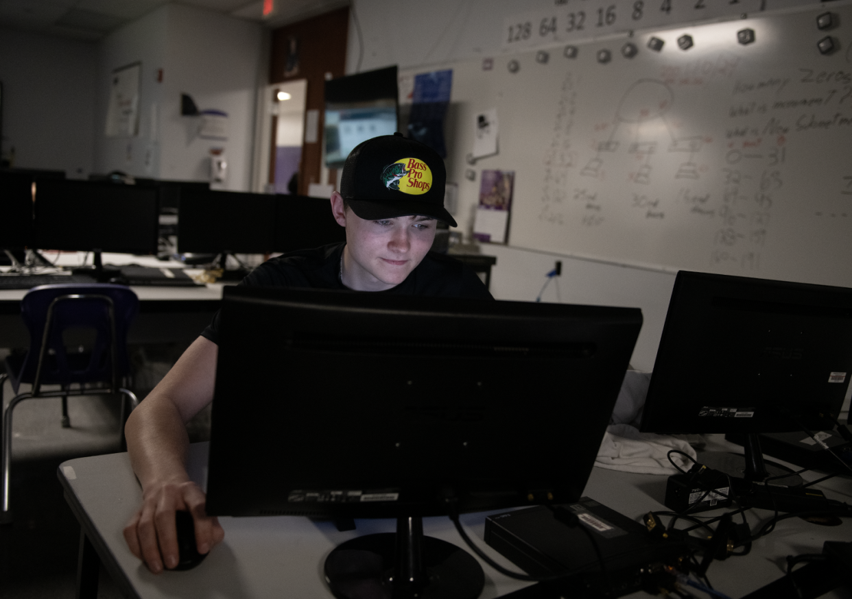 Tristin Curtis, 18, takes an online practice test for a certificate in the security operations center at Barberton High School.