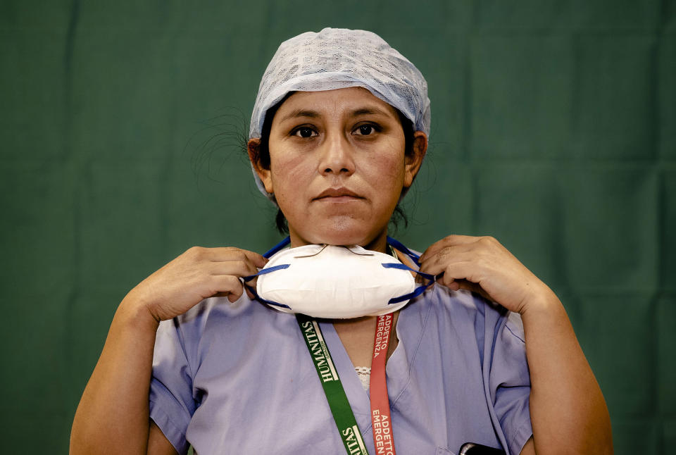 Image: Ana Travezano, 39, a nurse at the Humanitas Gavazzeni Hospital in Bergamo, Italy, poses for a portrait at the end of her shift Friday. (Antonio Calanni / AP)