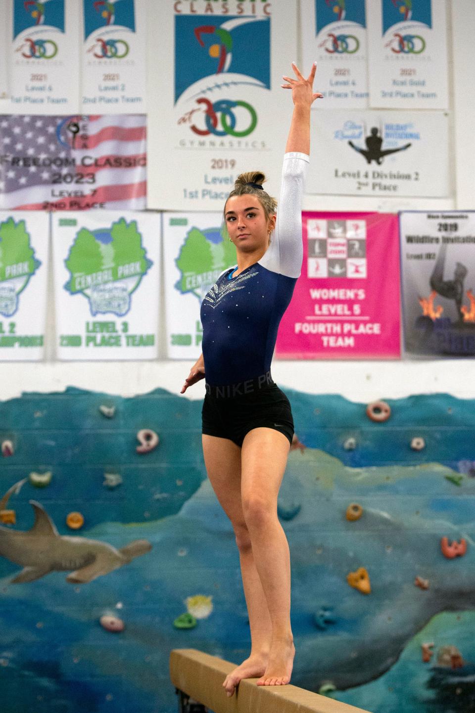 Framingham sophomore Olivia Lane warms up on the balance beam before the start of the meet at Shen's Gymnastics Academy in Holliston against Braintree, Feb. 7, 2023.