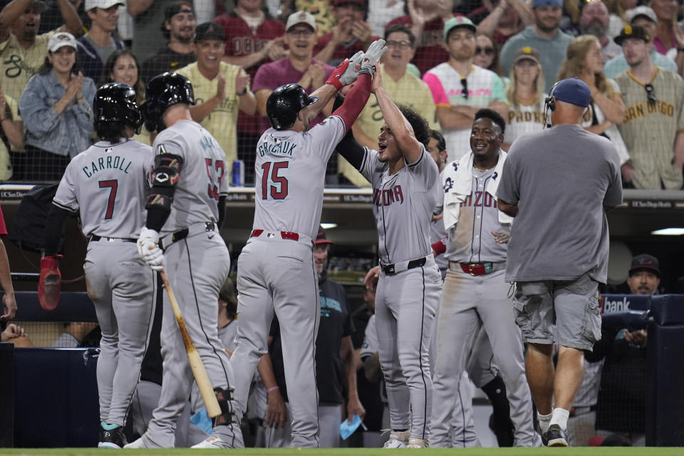 Arizona Diamondbacks' Randal Grichuk, (15) celebrates with teammate Alek Thomas after hitting a two-run home run during the ninth inning of a baseball game against the San Diego Padres, Friday, July 5, 2024, in San Diego. (AP Photo/Gregory Bull)