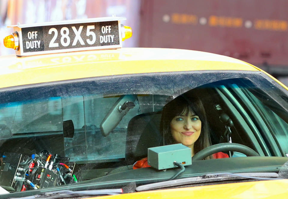 Dakota in the driver's side of a taxi