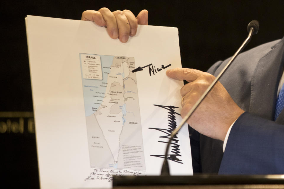 Israeli Prime Minister Benjamin Netanyahu shows a map from US President Donald Trump during statements to the press in Jerusalem, Thursday, May 30, 2019. President Donald Trump's son-in-law and senior adviser Jared Kushner met with Israeli Prime Minister Benjamin Netanyahu on Thursday to push the Trump administration's long-awaited plan for Mideast peace, just as Israel was thrust into the political tumult of an unprecedented second election in the same year. (AP Photo/Ariel Schalit)