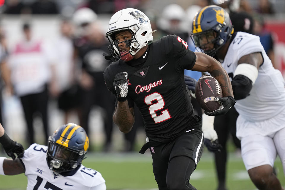 Houston wide receiver Matthew Golden (2) turns the corner on the way to a first down during the first quarter of the team's NCAA college football game against West Virginia, Thursday, Oct. 12, 2023, in Houston. (AP Photo/Kevin M. Cox)