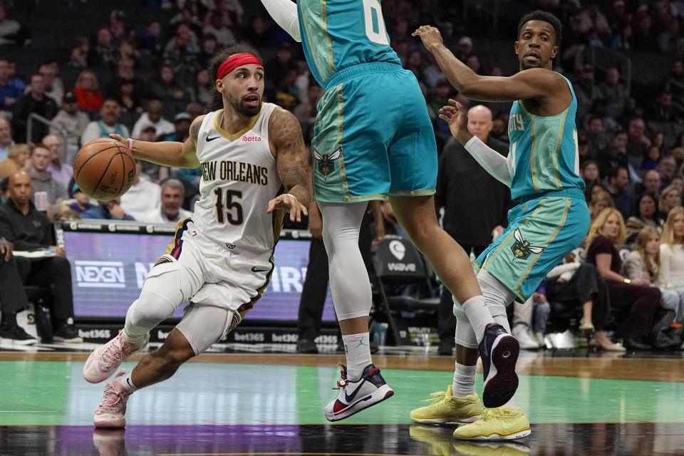 New Orleans Pelicans guard Jose Alvarado drives to the basket past Charlotte Hornets forward Miles Bridges during the first half of an NBA basketball game Friday, Dec. 15, 2023, in Charlotte, N.C. (AP Photo/Chris Carlson)