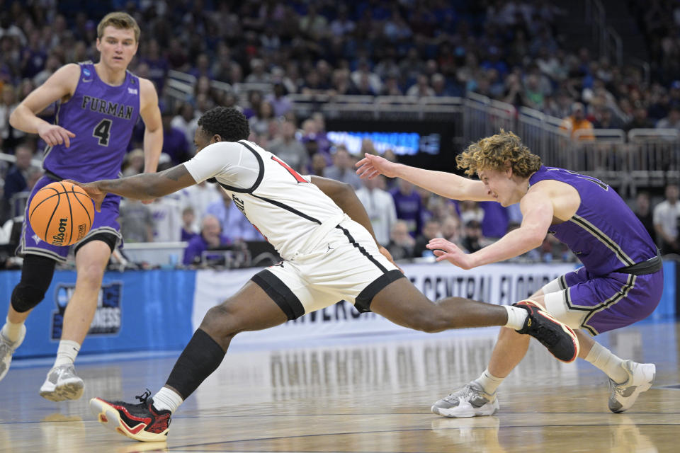 San Diego State guard Darrion Trammell fouls Furman guard Carter Whitt, right, while going for a steal during the first half of a second-round college basketball game in the NCAA Tournament, Saturday, March 18, 2023, in Orlando, Fla. (AP Photo/Phelan M. Ebenhack)