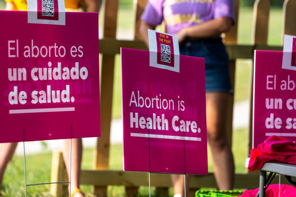 Planned Parenthood yard signs mark the site of a celebration rally at the Des Moines Biergarten at Water Works Park on Friday.