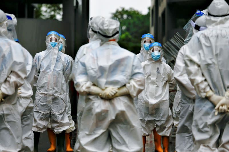 Healthcare workers prepare to treat patients at the emergency COVID-19 hospital in Athletes Village, Jakarta