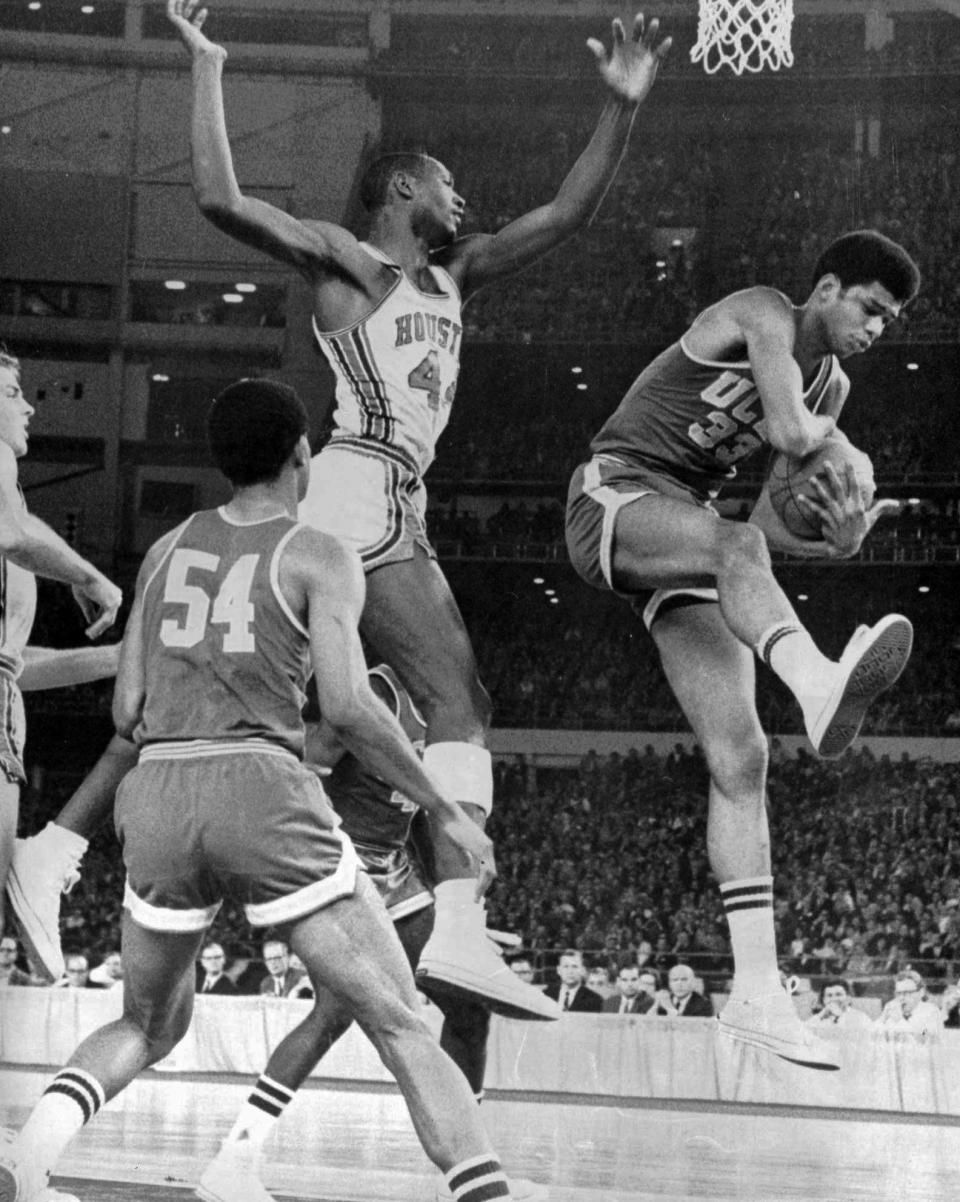 UCLA's Lew Alcindor (now Kareem Abdul Jabbar) grabs a rebound as Houston's Elvin Hayes tries to snag the ball in   action Jan. 20, 1968, during the "Game of the Century."