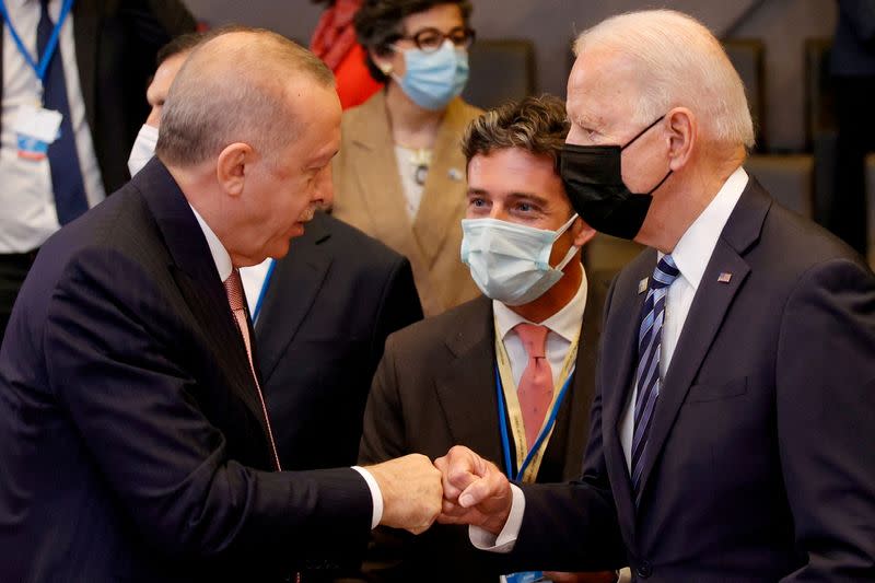 FILE PHOTO: Turkey's President Tayyip Erdogan fist bumps U.S. President Joe Biden during a plenary session at a NATO summit in Brussels