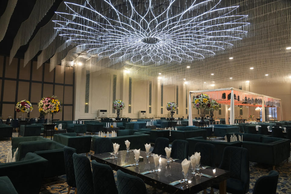 A decorated hall of the Manor marquee is ready for a wedding ceremony at a wedding halls compound, in Islamabad, Pakistan, Saturday, Jan. 20, 2024. Businessmen in the capital Islamabad have taken the idea of convenience and developed a wedding compound that sits next to a six-lane highway. There are a dozen venues in this location, some are marriage multiplexes offering more than one hall. (AP Photo/Anjum Naveed)