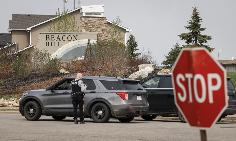 Police vehicles control access to the evacuated neighbourhood of Beacon Hill in Fort McMurray, Alta., on Wednesday, May 15, 2024. (Jeff McIntosh /The Canadian Press via AP)
