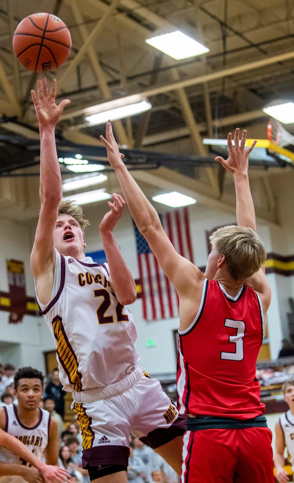 Bloomington North's Luke Lindeman (22) shoots over Center Grove's Marcus Ankney (3) during the Bloomington North versus Center Grove boys basketball game at Bloomington High School North on Friday, Dec. 2, 2022.