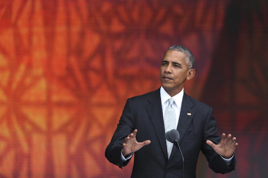 FILE - In this Saturday, Sept. 24, 2016 file photo, President Barack Obama speaks during the opening ceremony of the Smithsonian National Museum of African American History and Culture on the National Mall in Washington. "This is the place to understand how protest and love of country don't merely coexist but inform each other; how men can proudly win the gold for their country but still insist on raising a black-gloved fist; how we can wear an "I Can't Breathe" T-shirt and still grieve for fallen police officers," Obama said. "We're not a burden on America, or a stain on America, or an object of pity or charity for America. We're America." (AP Photo/Manuel Balce Ceneta)