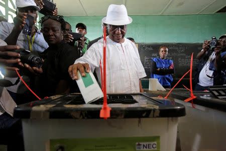 FILE PHOTO: Joseph Nyuma Boakai, Liberia's vice president and presidential candidate of Unity Party (UP), votes at a polling station in Monrovia, Liberia, October 10, 2017. REUTERS/Thierry Gouegnon