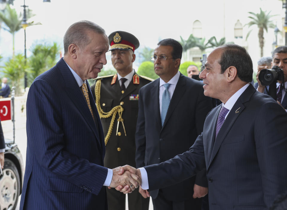 In this handout photo released by Turkish Presidency, Turkey's President Recep Tayyip Erdogan, left, is welcomed by Egyptian President Abdel Fattah Al-Sissi for their meeting at Al-Ittihadiya palace in Cairo, Egypt, Wednesday, Feb. 14, 2024. (Turkish Presidency via AP)