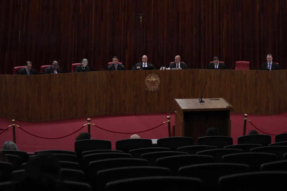 President of the Supreme Electoral Court, Minister Alexandre de Moraes, center, presides over the trial of former President Jair Bolsonaro at the Supreme Court in Brasilia, Brazil, Friday, June 30, 2023. Judges continue evaluating the case which claims Bolsonaro abused his power by using government communication channels to promote his campaign and cast unfounded doubts on the country's electronic voting system. (AP Photo/Eraldo Peres)