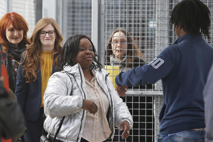 Tondalao Hall, center, greets family members following her release from Mabel Bassett Correctional Center in McLoud, Okla., Friday, Nov. 8, 2019. Hall, who was convicted of failing to report her boyfriend for abusing her children, spent about 13 years longer in prison than he did for the abuse. (AP Photo/Sue Ogrocki)