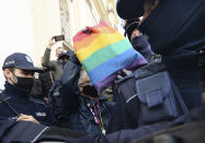 Members of a far-right organization and police remove women from a church where they were protesting church support for tightening Poland's already restrictive abortion law in Warsaw, Poland, Sunday, Oct. 25, 2020. Poland constitutional court issued a ruling on Thursday that further restricts abortion rights in Poland, triggering four straight days of protests across Poland.(AP Photo/Czarek Sokolowski)