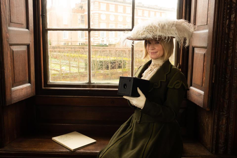 British historian Lucy Worsley in period costume with a vintage Kodak camera to recreate the photographs of Queen Alexandra for "Lucy Worsley's Royal Photo Albums" on PBS on Aug. 16.