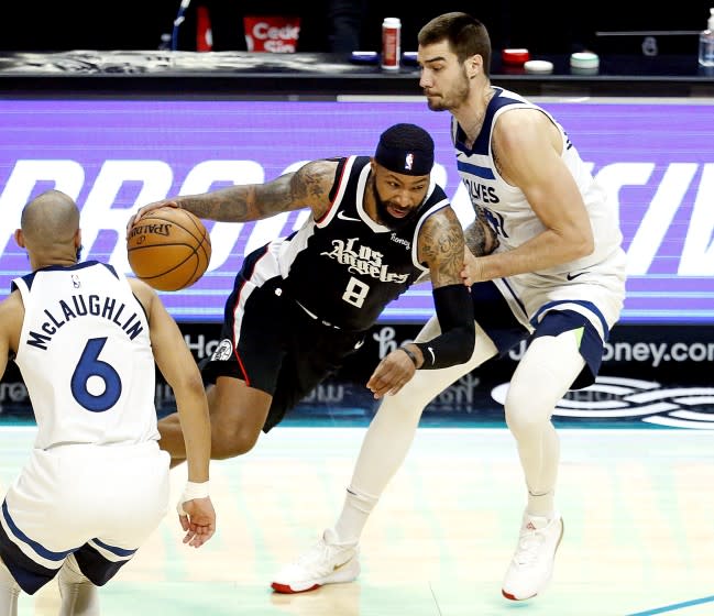 LOS ANGELES, CA - APRIL 18: LA Clippers forward Marcus Morris Sr. (8) drives to the basket guarded by Minnesota Timberwolves forward Juancho Hernangomez (41) in the third quarter at the Staples Center on Sunday, April 18, 2021 in Los Angeles, CA. (Gary Coronado / Los Angeles Times)