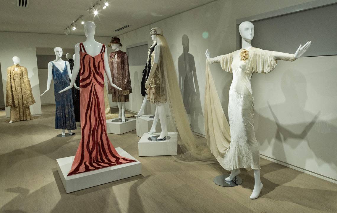 View of dresses including (from left) the “Flame Dress,” from 1926 made of pink silk with red velvet by Madeleine Vionnet; a wedding dress white tulle with gold embroidery by Paul Poiret from the 1920s and an evening dress, beige silk velvet by Elsa Schiaparelli, from 1930s. Pedro Portal/pportal@miamiherald.com