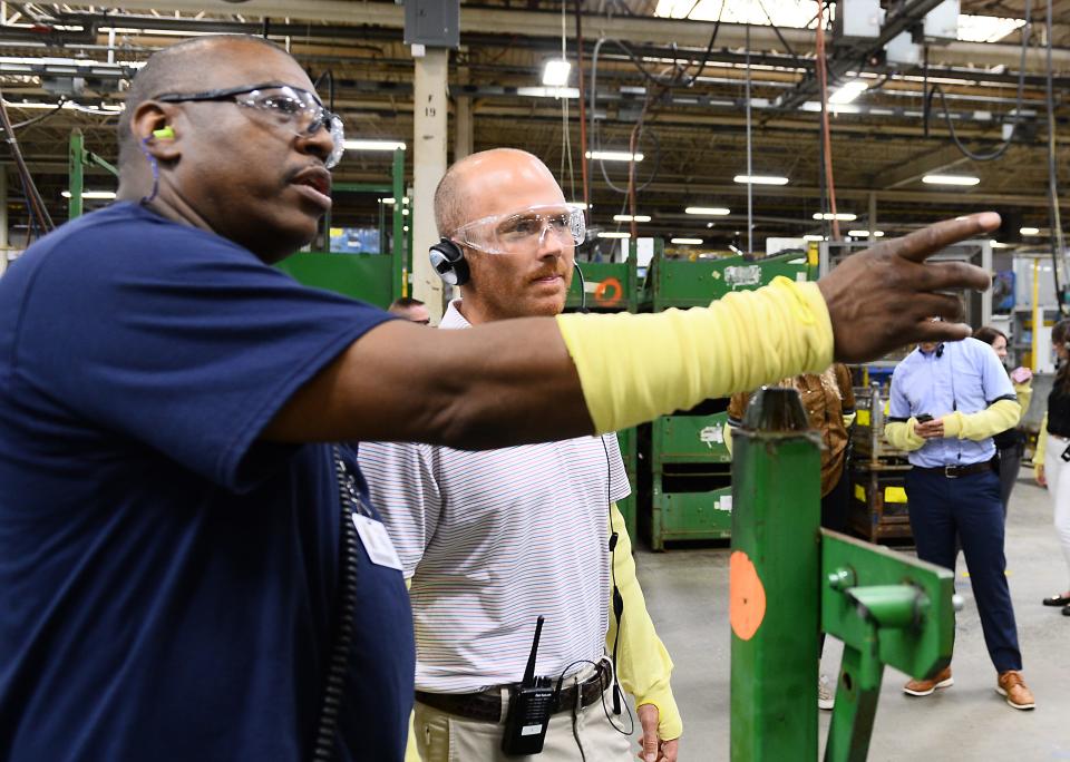 Rodney Tidwell of Spartanburg Steel Products, left, talks about facility operations with Congressman Timmons.