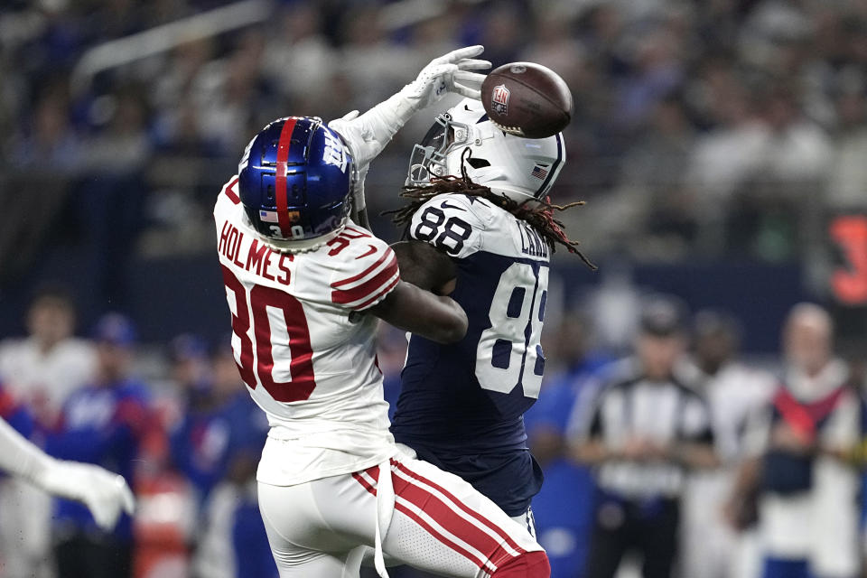 New York Giants cornerback Darnay Holmes (30) tips a pass intended for Dallas Cowboys wide receiver CeeDee Lamb (88) which was intercepted by safety Julian Love during the first half of an NFL football game Thursday, Nov. 24, 2022, in Arlington, Texas. (AP Photo/Tony Gutierrez)