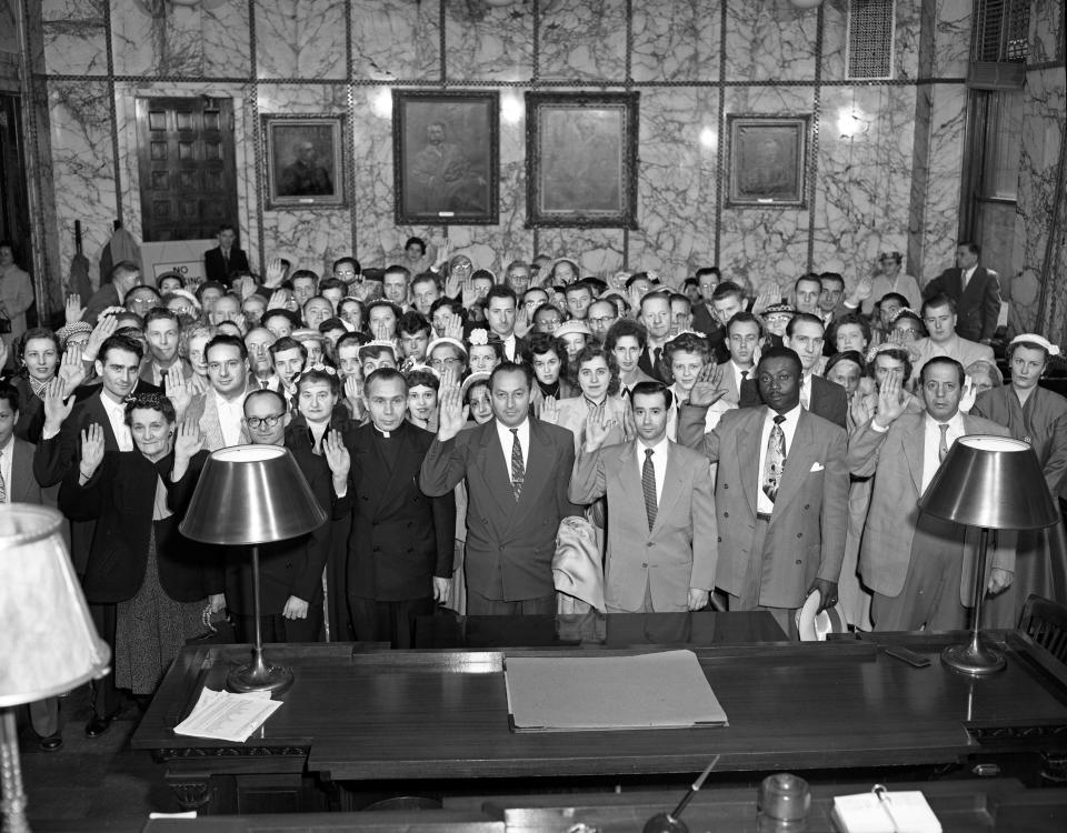 In this November 1954 archive photo, some 200 were sworn in as United States citizens Thursday morning at the federal building in Milwaukee. Federal judge Robert E. Tehan administered the oath in his courtroom. The ceremony was part of a country-wide mass naturalization program in which 50,000 persons became citizens.