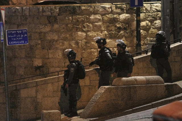 Israeli Border Police are deployed near the Lions' Gate to the Old City of Jerusalem during a raid by police at the Al-Aqsa Mosque compound, Wednesday, April 5, 2023. Palestinian media reported police attacked Palestinian worshippers, raising fears of wider tension as Islamic and Jewish holidays overlap.(AP Photo/Mahmoud Illean)
