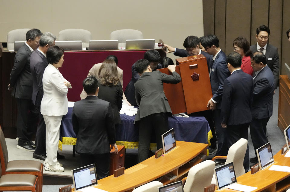 National Assembly staffs and lawmakers empty a box containing ballots cast at the National Assembly in Seoul, South Korea, Thursday, Sept. 21, 2023. In a surprise outcome, South Korea’s opposition-controlled parliament on Thursday voted to pass a motion submitted by the government that allows for the potential arrest of the country’s leading opposition figure, Lee Jae-myung, who faces a widening investigation over corruption allegations.(AP Photo/Ahn Young-joon)