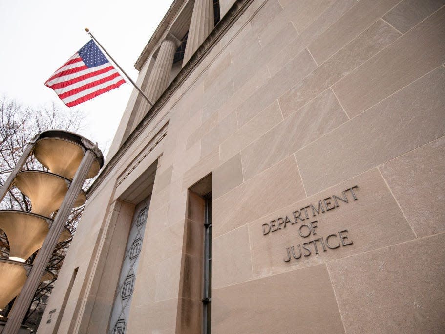 A flag waves outside the federal Department of Justice building in Washington, DC
