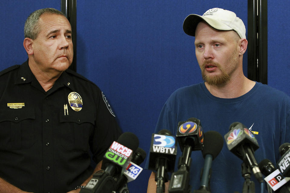 Gastonia Police Chief Robert Helton, left, listens as Ian Ritch speaks during a press conference Wednesday, Sept. 26, 2018, in Gastonia, N.C., about his 6-year-old son Maddox Ritch who disappeared while they were visiting Rankin Lake Park near downtown Gastonia Saturday, Sept. 22, 2018. (John Clark /The Gaston Gazette via AP)