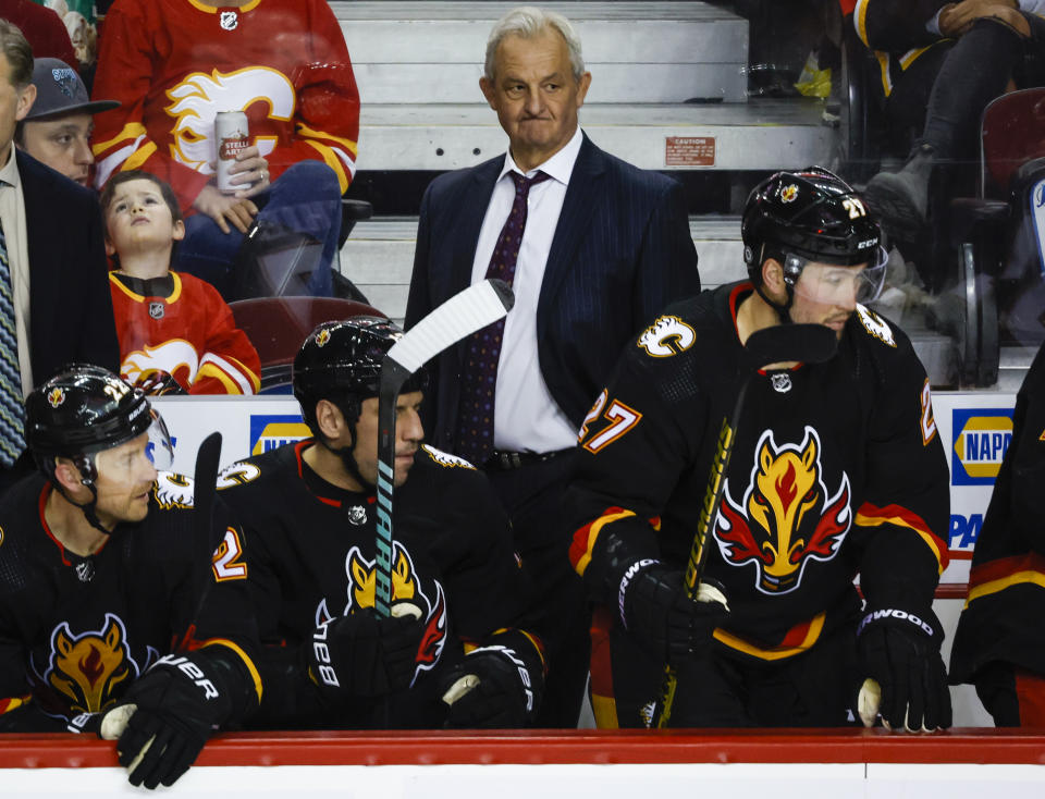 Calgary Flames head coach Darryl Sutter, center, watches the play during third-period NHL hockey game action against the Vegas Golden Knights in Calgary, Albera, Thursday, March 23, 2023. (Jeff McIntosh/The Canadian Press via AP)